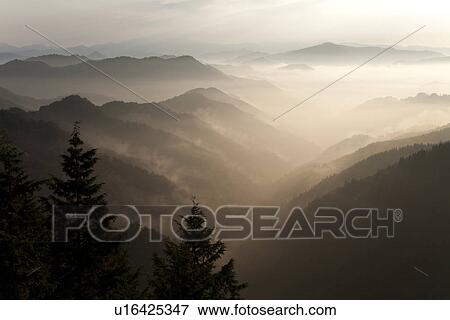 Stock Photo - Mountain range surrounded by fog. Fotosearch
