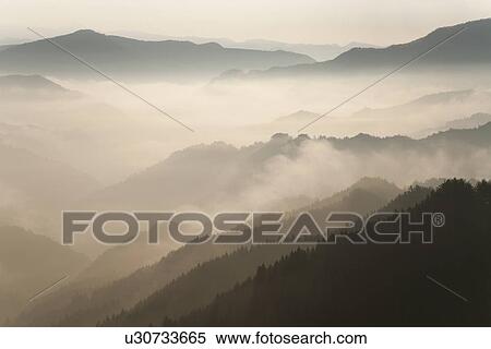 Stock Photography - Mountain range surrounded by fog. Fotosearch