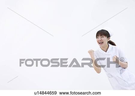 Stock Photo - Nurse doing victory pose. Fotosearch