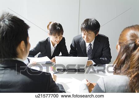 Stock Image - Office workers in a meeting. Fotosearch