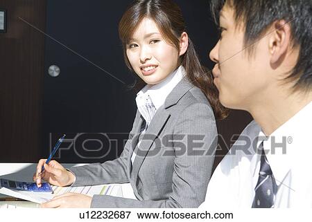 Stock Photo - Office workers in a meeting. Fotosearch