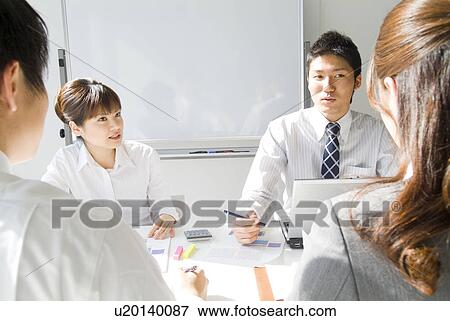 Stock Photo - Office workers in a meeting. Fotosearch