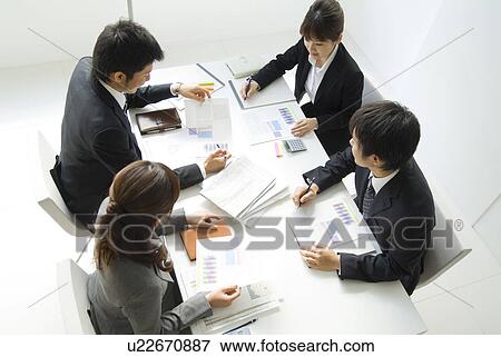 Stock Photo - Office workers in a meeting. Fotosearch