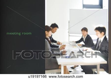 Stock Photograph - Office workers in a meeting. Fotosearch