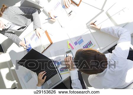 Office workers planning in a meeting View Large Photo Image Stock Photograph - Office workers planning in a meeting. Fotosearch