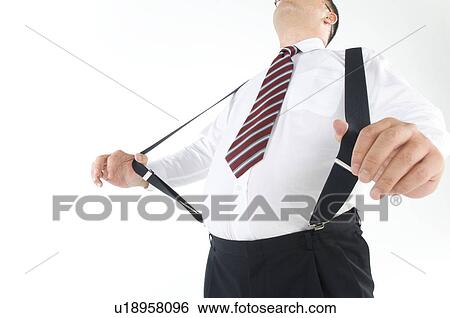 Stock Photograph - Overweight businessman with a pot belly stretching his suspenders. Fotosearch