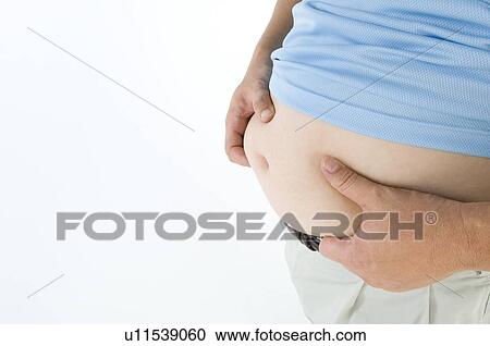 Overweight man pinching his pot belly View Large Photo Image Stock Image - Overweight man pinching his pot belly. Fotosearch