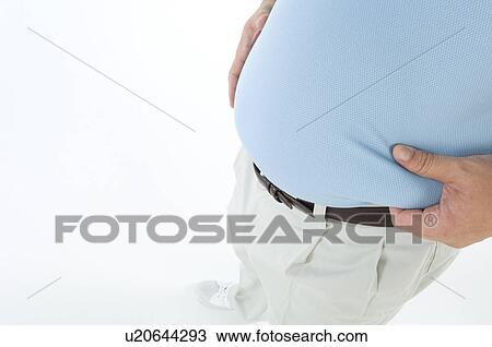 Stock Image - Overweight man pinching his pot belly. Fotosearch