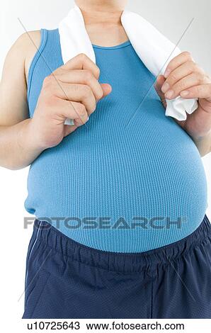 Stock Image - Overweight man with a pot belly in gym gear. Fotosearch
