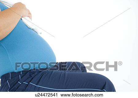 Stock Image - Overweight man with a pot belly in gym gear. Fotosearch
