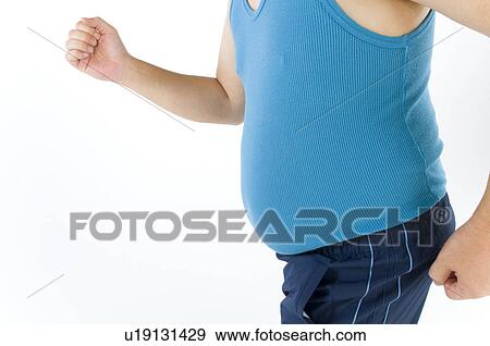Stock Photo - Overweight man with a pot belly in gym gear. Fotosearch