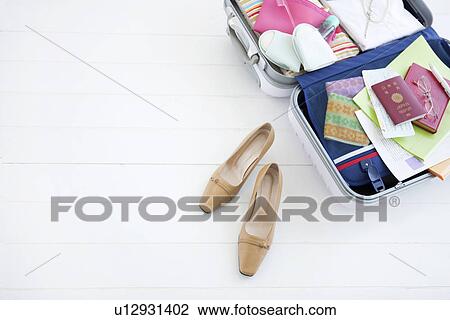 Stock Image - Packed suitcase lying open. Fotosearch