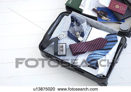 Packed suitcase lying open View Large Photo Image Stock Image - Packed suitcase lying open. Fotosearch
