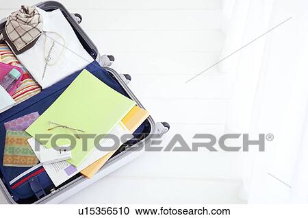 Stock Image - Packed suitcase lying open. Fotosearch