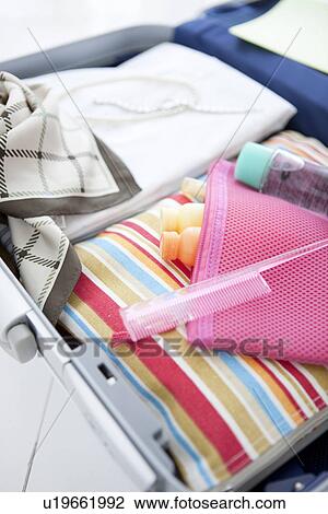 Stock Image - Packed suitcase lying open. Fotosearch