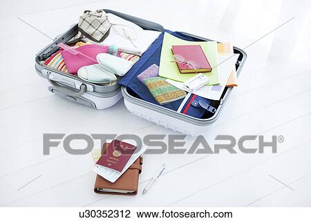 Stock Image - Packed suitcase lying open. Fotosearch