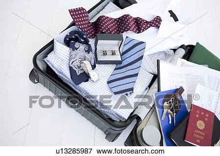 Packed suitcase lying open View Large Photo Image Stock Photo - Packed suitcase lying open. Fotosearch