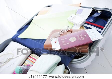 Packed suitcase lying open View Large Photo Image Stock Photo - Packed suitcase lying open. Fotosearch