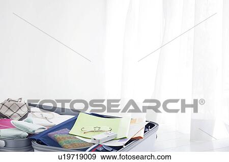 Packed suitcase lying open View Large Photo Image Stock Photo - Packed suitcase lying open. Fotosearch