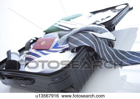 Stock Photograph - Packed suitcase lying open. Fotosearch