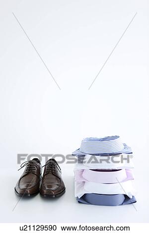 Pair of shoes and folded shirts View Large Photo Image Stock Image - Pair of shoes and folded shirts. Fotosearch
