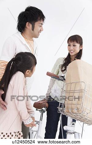 Picture - Parents and daughter with a bicycle. Fotosearch