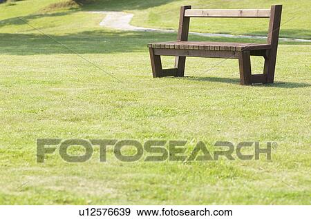 Park lawn and an empty bench View Large Photo Image Stock Photo - Park lawn and an empty bench. Fotosearch