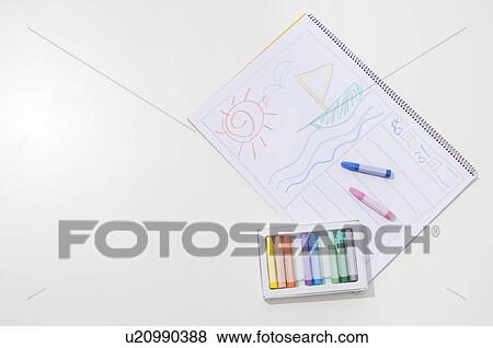 Stock Photo - Pastel crayons and a drawing on a notepad. Fotosearch