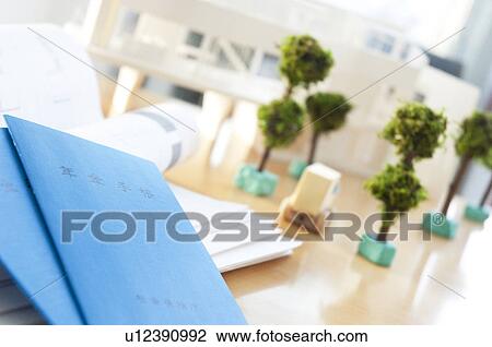 Stock Image - Pension booklet and model trees. Fotosearch