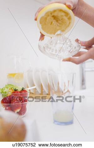 Person juicing grapefruit View Large Photo Image Stock Image - Person juicing grapefruit. Fotosearch