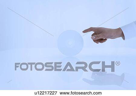 Stock Photo - Person reaching towards compact disc. Fotosearch