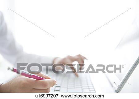Stock Photo - Person typing on laptop. Fotosearch
