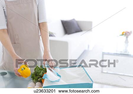 Person unpacking groceries from eco-bag View Large Photo Image Stock Image - Person unpacking groceries from eco-bag. Fotosearch