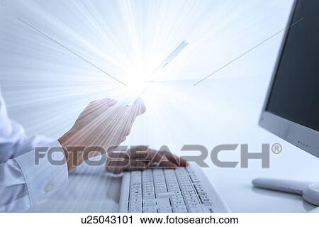 Stock Image - Person using mobile phone with solar flare. Fotosearch