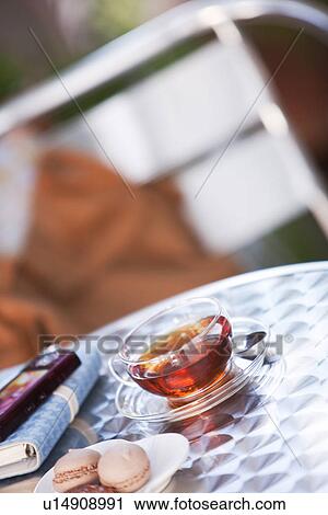 Plate of cookies and a cup of tea on a table with a cellphone and diary View Large Photo Image Stock Image - Plate of cookies and a cup of tea on a table with a cellphone and diary. Fotosearch