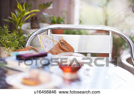 Plate of cookies and a cup of tea on a table with a cellphone and diary View Large Photo Image Stock Photograph - Plate of cookies and a cup of tea on a table with a cellphone and diary. Fotosearch