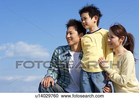 Portrait of a family with young son against a blue sky View Large Photo Image Stock Image - Portrait of a family with young son against a blue sky. Fotosearch