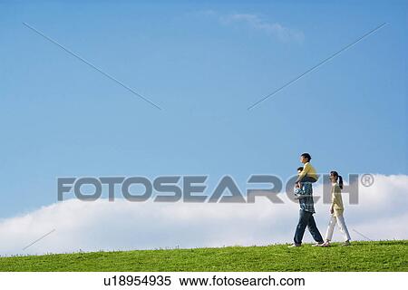 Portrait of a family with young son walking in the park against a blue sky View Large Photo Image Stock Photography - Portrait of a family with young son walking in the park against a blue sky. Fotosearch