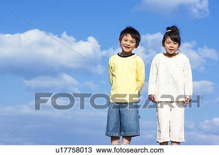 Portrait of brother and sister against a blue sky View Large Photo Image Stock Image - Portrait of brother and sister against a blue sky. Fotosearch