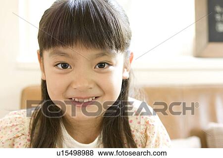 Stock Photo - Portrait of smiling little girl. Fotosearch