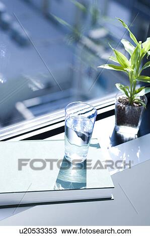 Potted plant and glass of water on window sill View Large Photo Image Stock Image - Potted plant and glass of water on window sill. Fotosearch