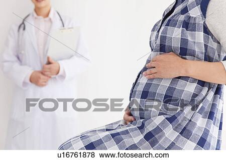Stock Photo - Pregnant woman with gynecologist. Fotosearch