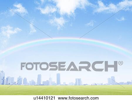 Stock Image - Rainbow over skyline and field. Fotosearch