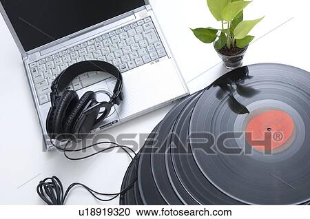 Stock Image - Records next to a laptop and headphones. Fotosearch