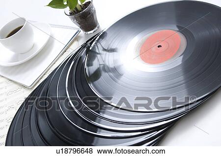 Stock Photo - Records next to a pot plant and a coffee cup. Fotosearch