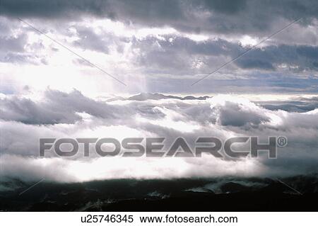Stock Photography - Sea of clouds over a mountain range. Fotosearch