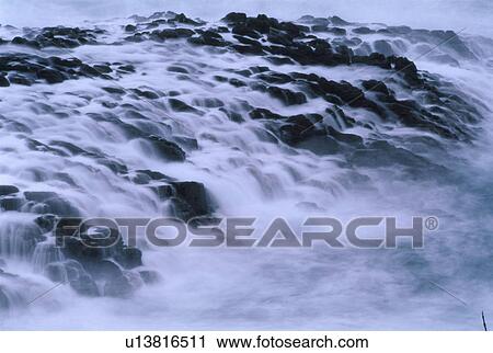 Sea water flowing over rocks View Large Photo Image Stock Image - Sea water flowing over rocks. Fotosearch