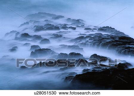 Sea water flowing over rocks with fog View Large Photo Image Stock Image - Sea water flowing over rocks with fog. Fotosearch