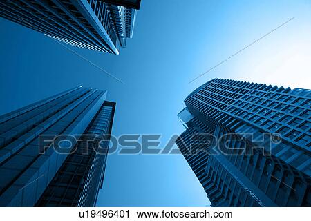 Stock Image - Skyscrapers and grey sky. Fotosearch