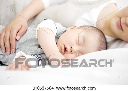 Sleeping mother and baby View Large Photo Image Picture - Sleeping mother and baby. Fotosearch